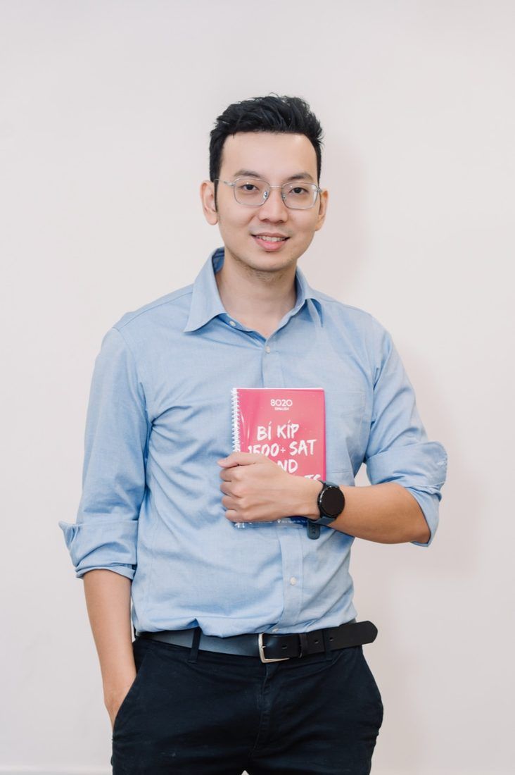 Rogers Tuong, academic head, holding the 8020 SAT handbook